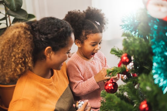 Mom and daugther decorating tree